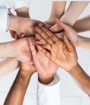 Multiple hands in a huddle