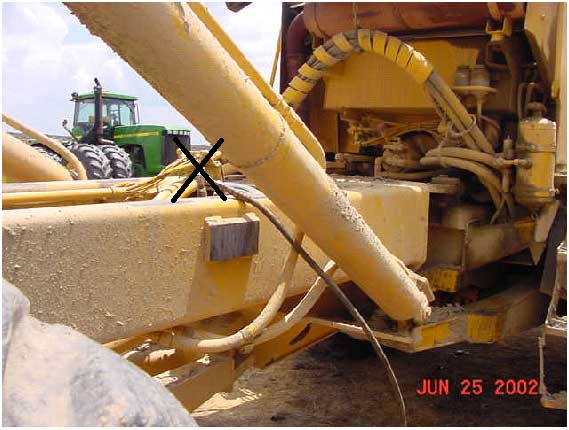 Area of truck where victim was working. Note the grease gun's rubber hose. Shows approximate location of victim following incident.