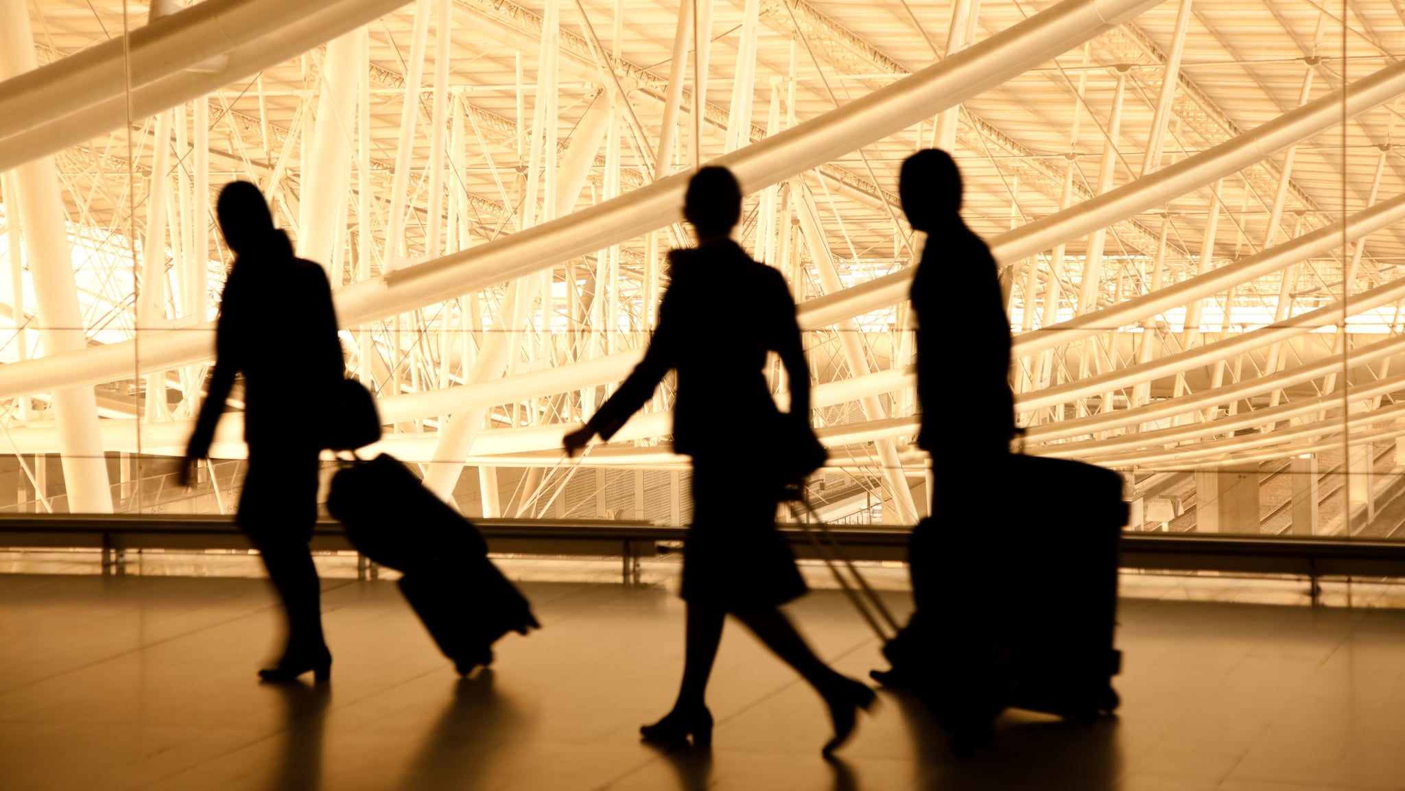 Aircrew members carrying luggage between flights