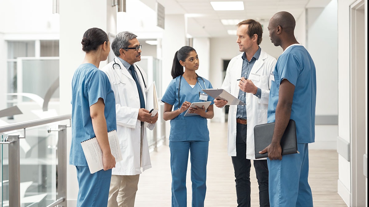 Doctors and nurses in medical meeting demonstrating teamwork, leadership and collaborative communication in a clinic