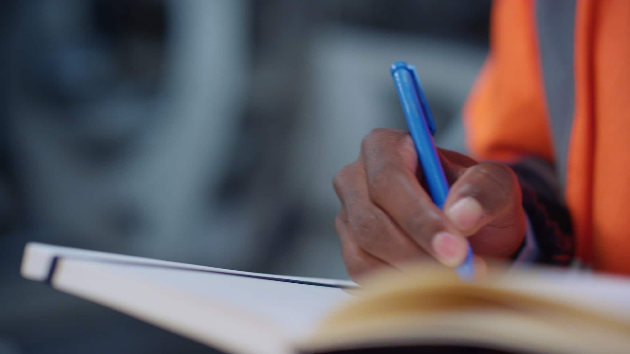 Close up of hand and pen taking notes for an inspection.