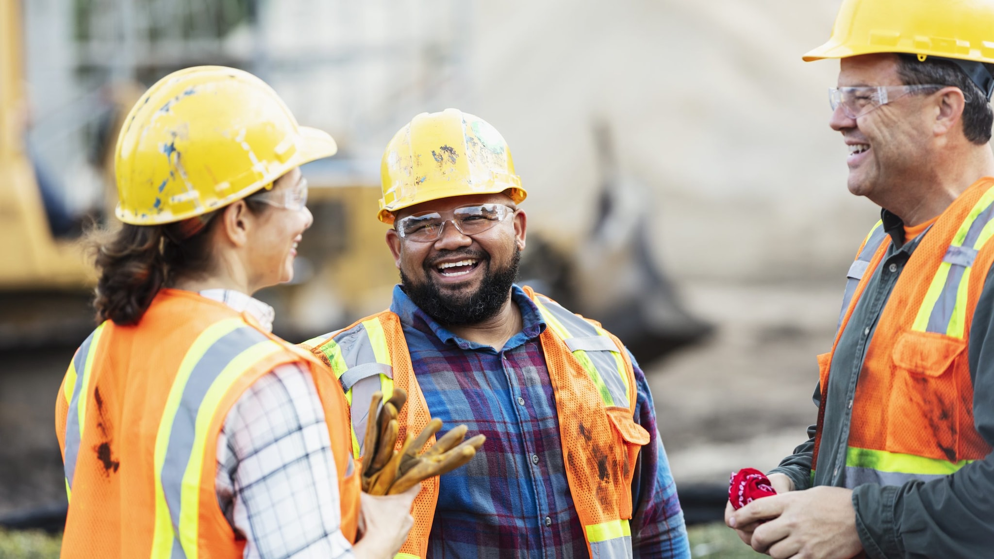 Three multi-ethnic construction workers chatting