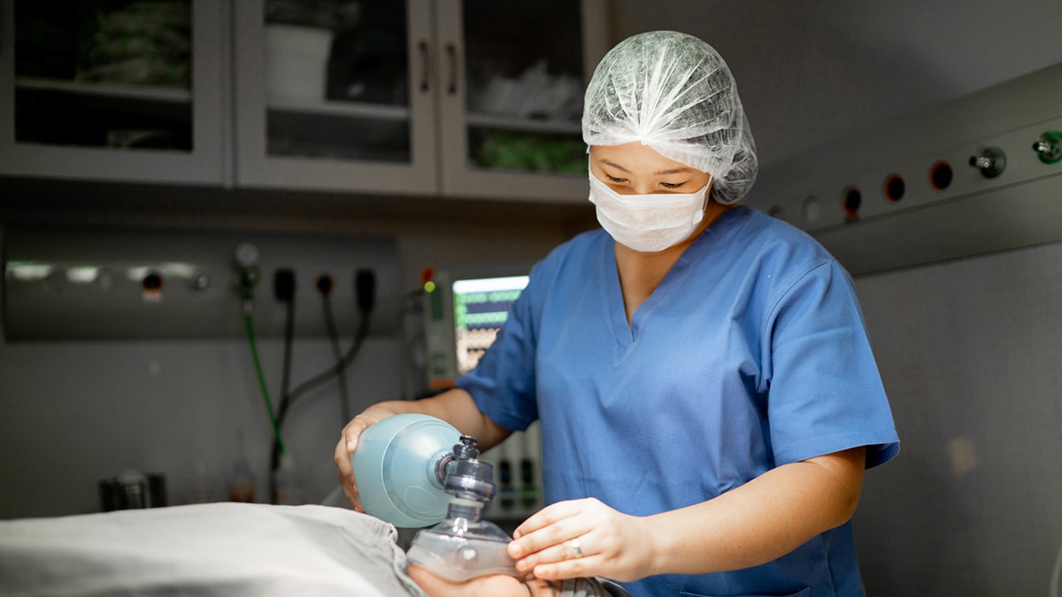 Healthcare worker providing anesthetic gas to patient