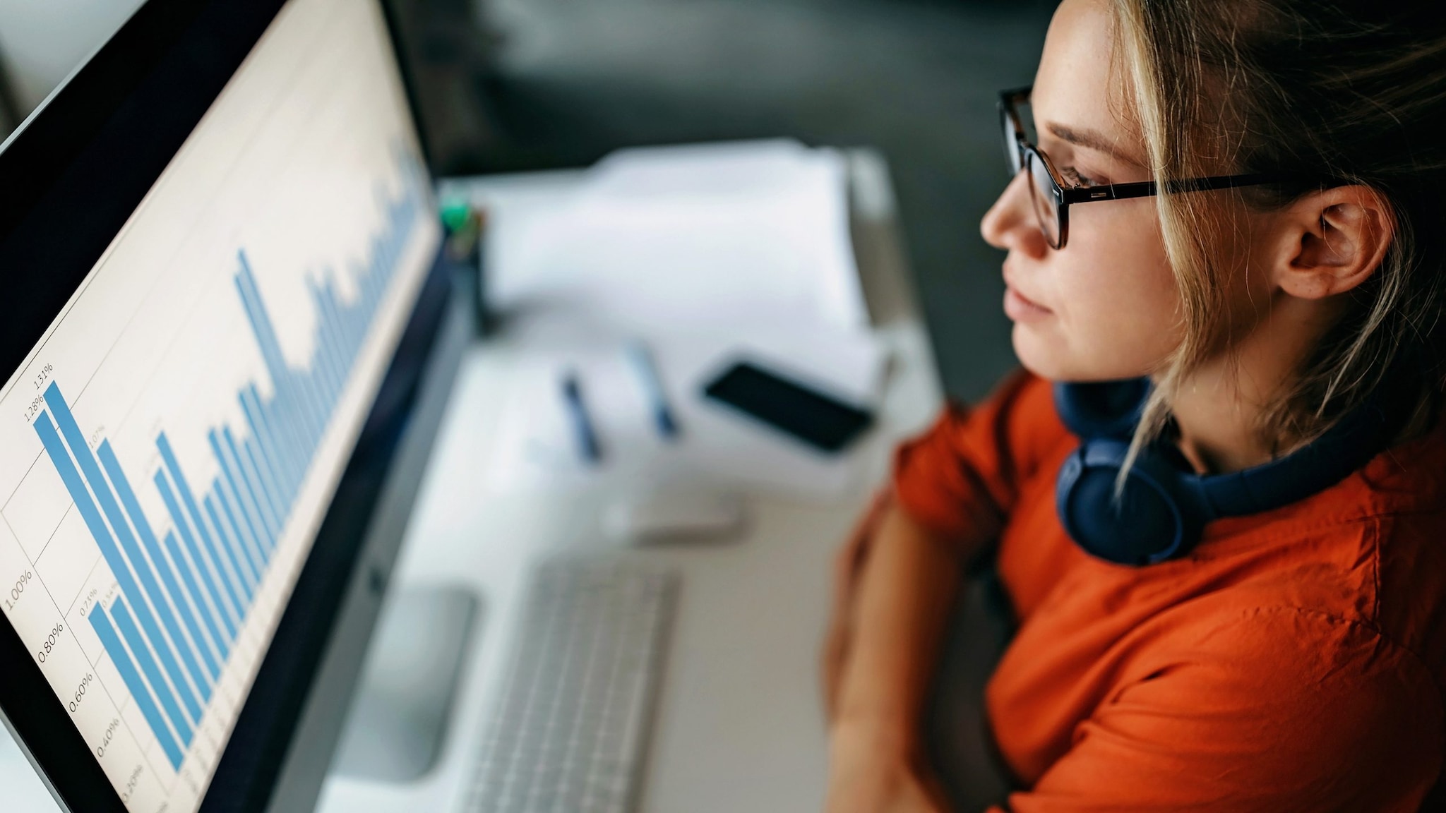 Woman looking at data trends on computer