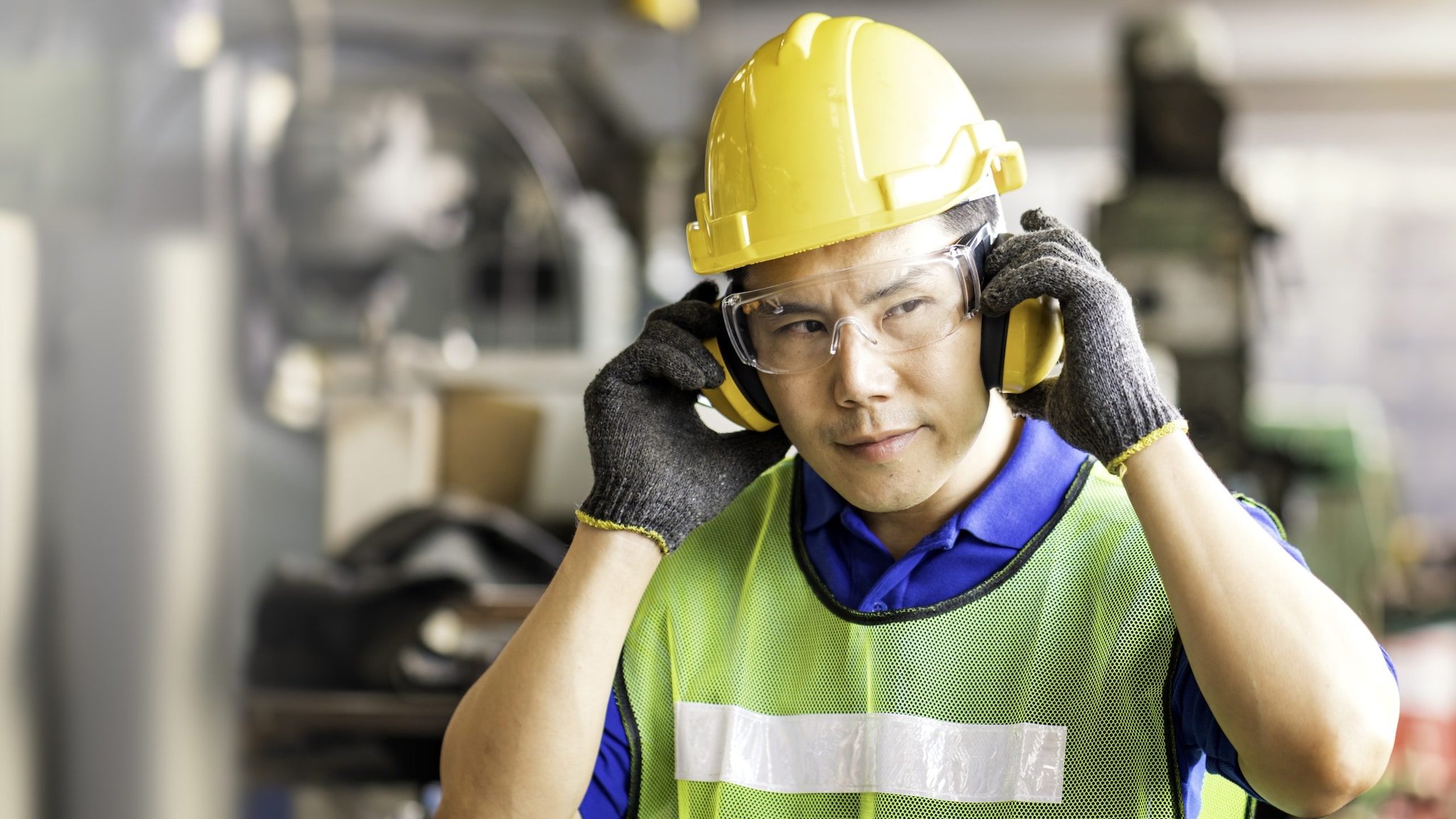 A man wearing protection while working. Photo by Thirawatana Phaisalratana/ GettyImages