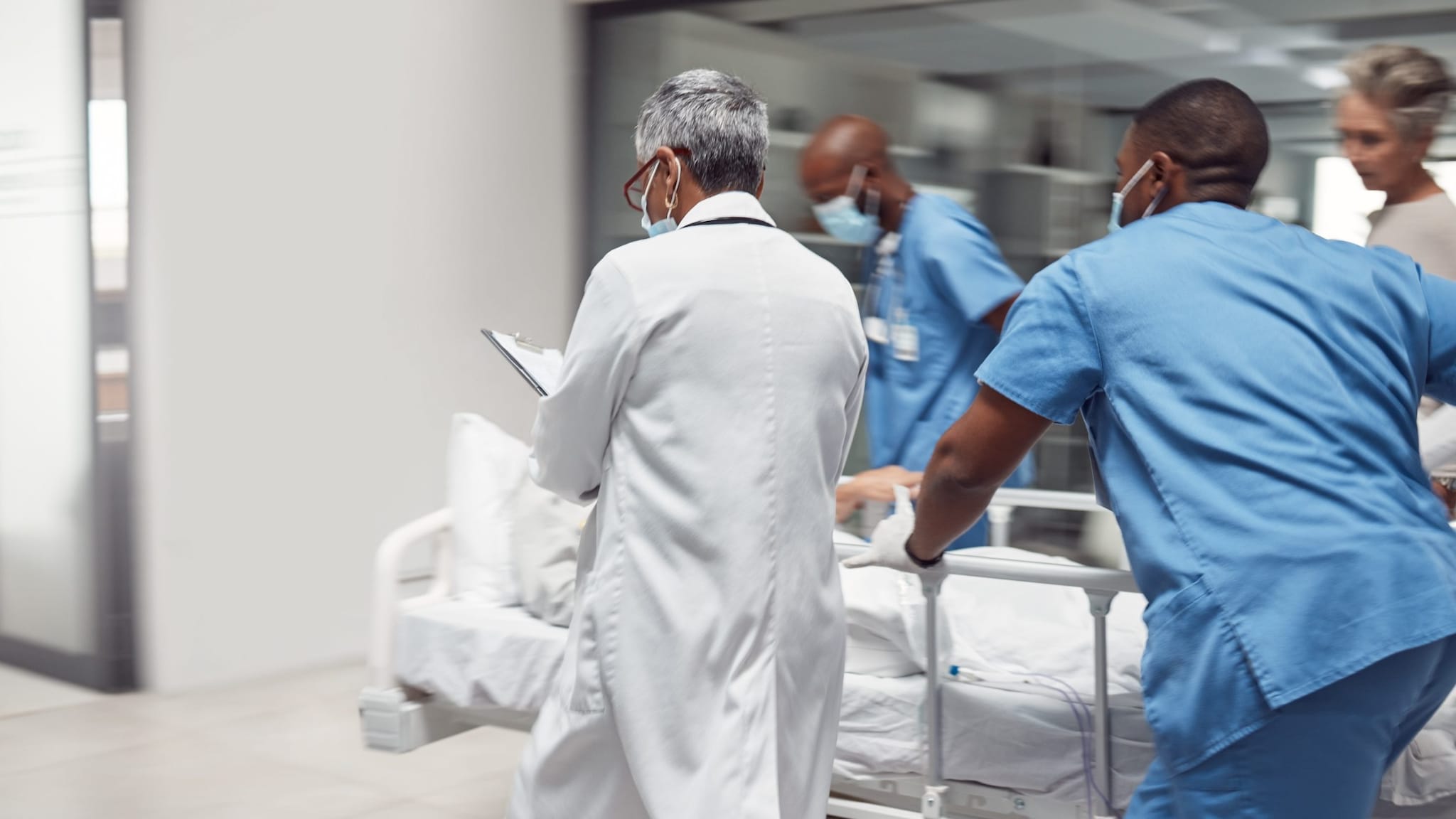 Doctors rush with patient, surgery and ready for procedure in hospital.