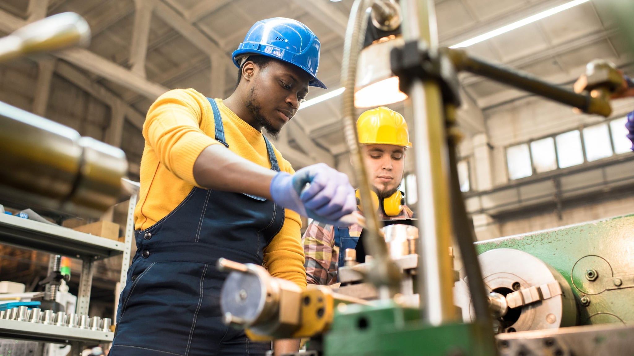 lathe operators wearing protective helmets