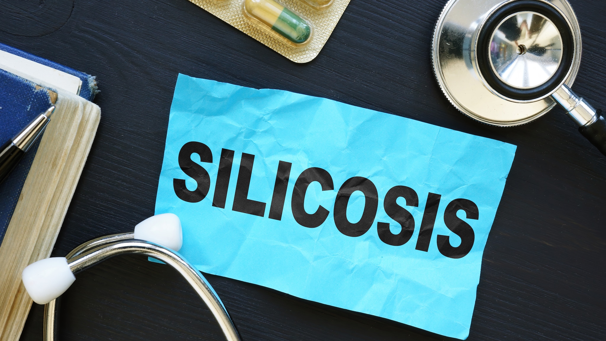 The word "silicosis" on a sticky note.