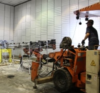 NIOSH researcher using jumbo drill to measure noise emissions in hemi-anechoic chamber