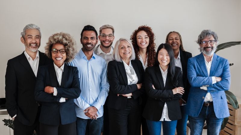 a group of older workers smiling for the camera