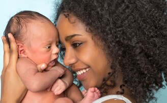 Smiling African mother and baby