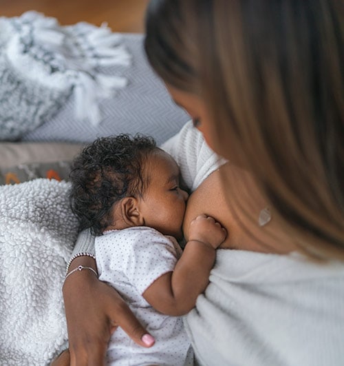 A mother breastfeeding her newborn child