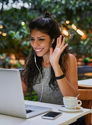 A woman in a video conference call at a coffee shop