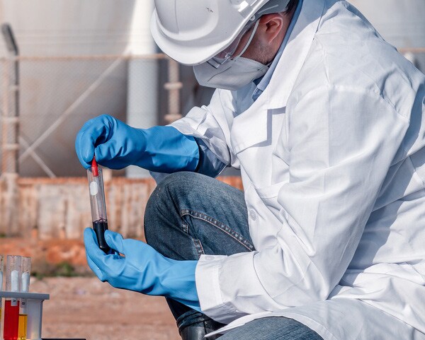 non-laboratory potentially infectious materials guidance lab worker wearing PPE and handling samples