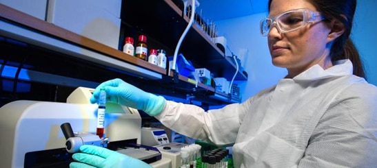 This photograph depicts an Enteric Diseases Laboratory Branch (EDLB), Public Health scientist, who was testing bacterial samples for their antimicrobial susceptibility.