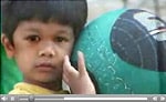 Video still of a young boy with a ball