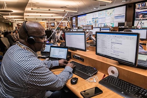 Man seated in front of a computer typing on a keyboard