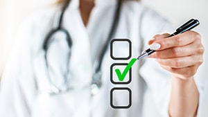 A healthcare professional draws a checkmark