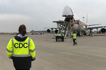 A Public Health Officer awaiting the arrival of an aircraft.