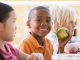 Young boy eating a green apple