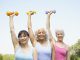 Three older women lifting dumbbells