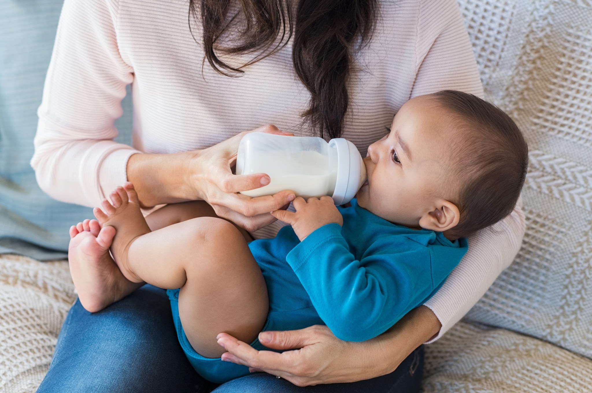 Parent feeding infant with a bottle