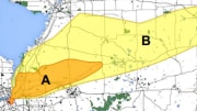 An arial view of a city map with colored shapes indicating areas of radiation exposure due to fallout.