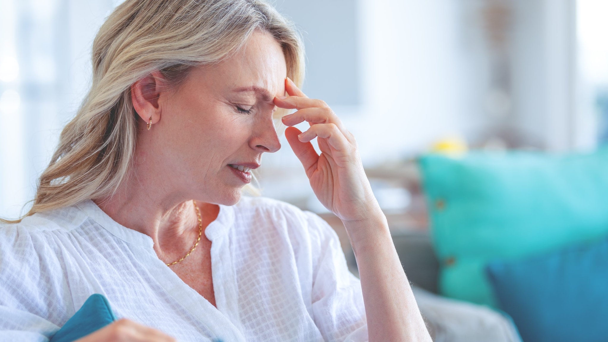 Woman not feeling well holding her head.