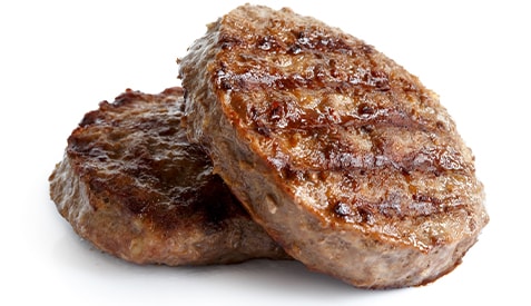 Two ground beef patties on a white background.