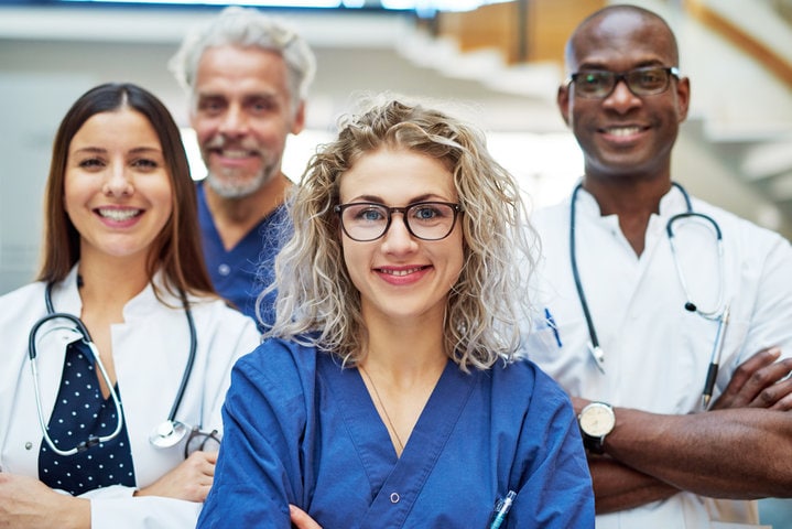 Four smiling healthcare professionals.