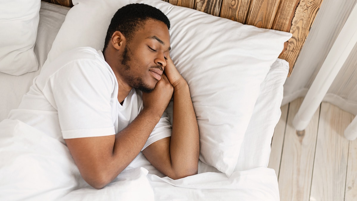 A man sleeping in bed.