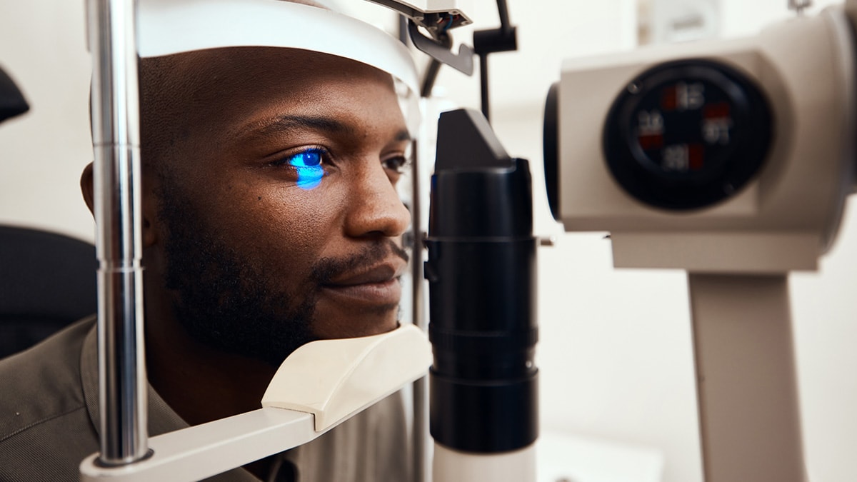 Man with his head in an eye-scanning device.