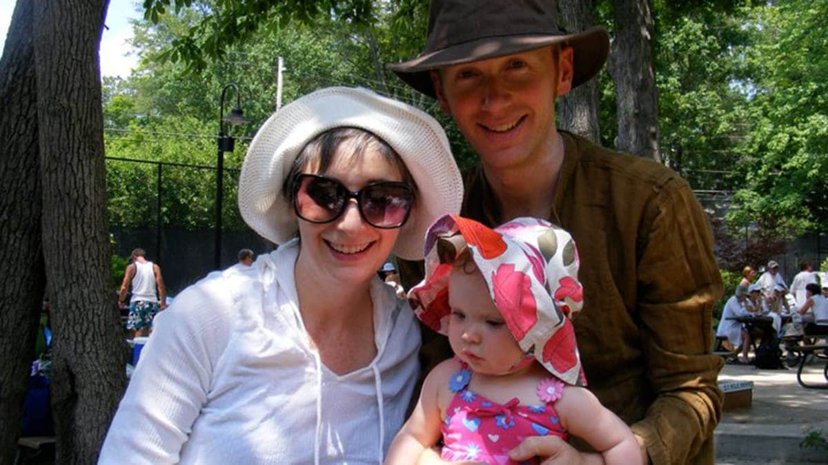 Meg Watson with husband and child wearing sun protection gear.