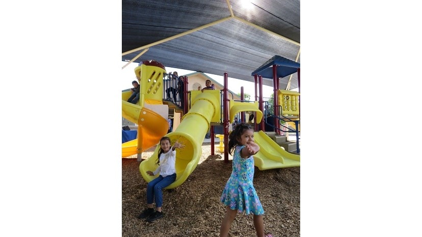 Children playing under a shade structure funded by the American Academy of Dermatology