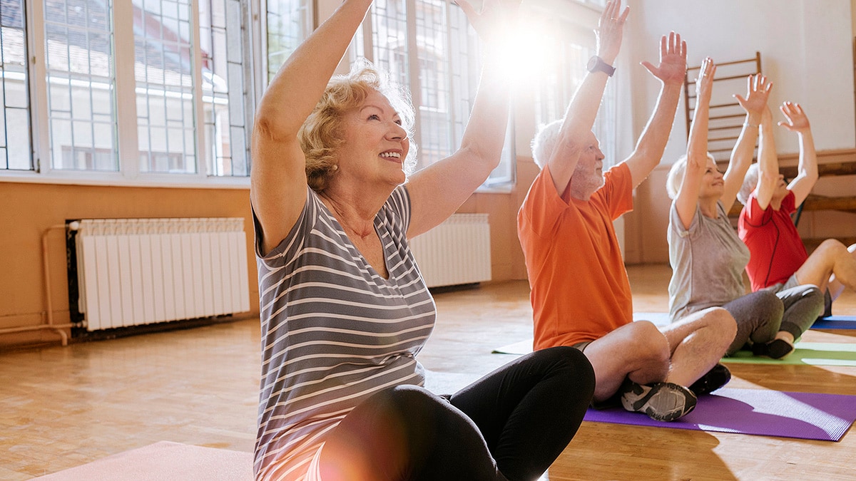 Group of older adults enjoying yoga.