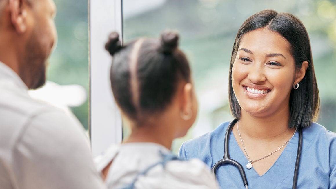 Child and dad talking with doctor