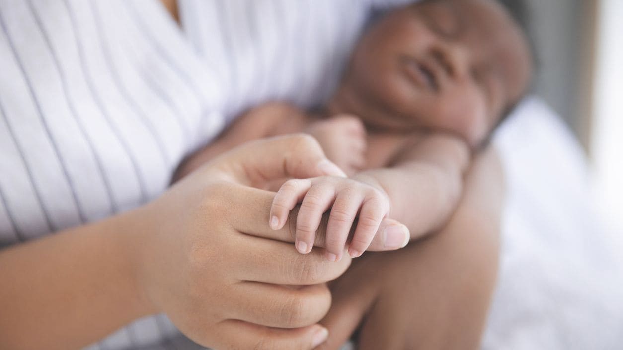 Baby being held by an adult