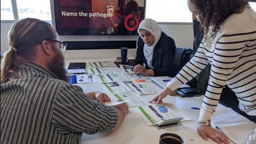 three people staring at training materials