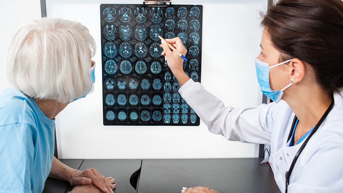 Doctor explains to an elderly woman the results of an MRI scan