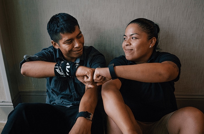 Man and women giving each other a fist bump.