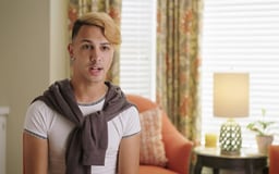 Hispanic male in room with window and chair behind him talking to camera