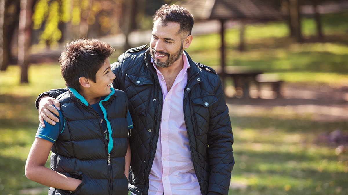 A man walking with his son.