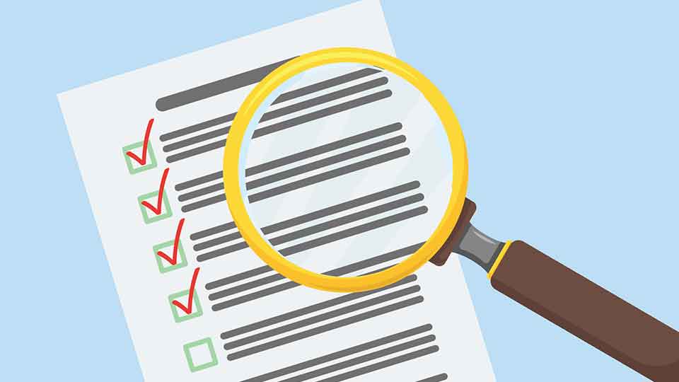 Magnifying glass hovering over a document checklist.