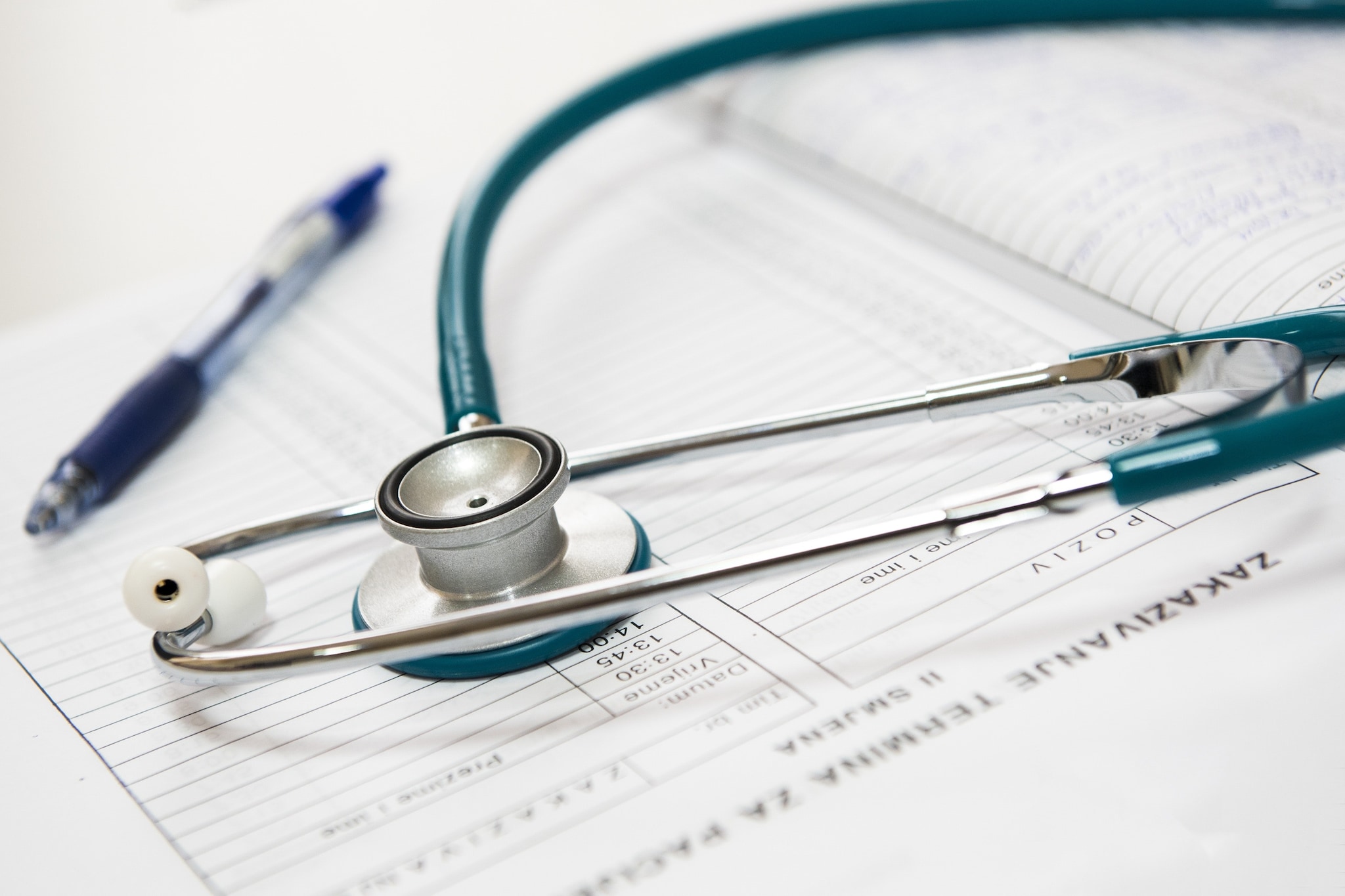 Stethoscope and pen on appointment book