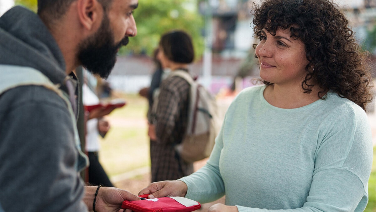 A syringe services program (SSP) worker smiles at a client.