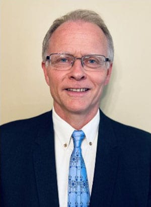 Headshot of Dr. Andrew Hill, PhD with neutral background