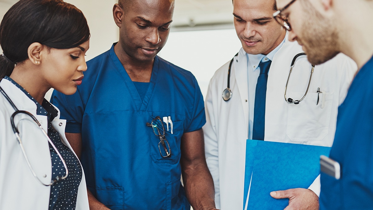 Group of healthcare providers looking at medical chart