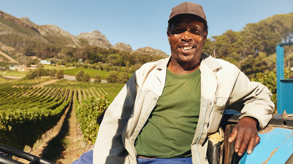 Smiling farmer sitting on a tractor.