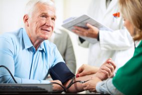 Picture of a senior man getting his blood pressure taken.