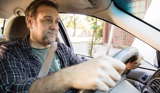 man driving a car